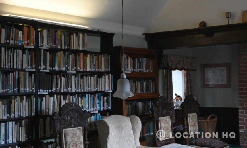 Panelled library with antique books and historic décor