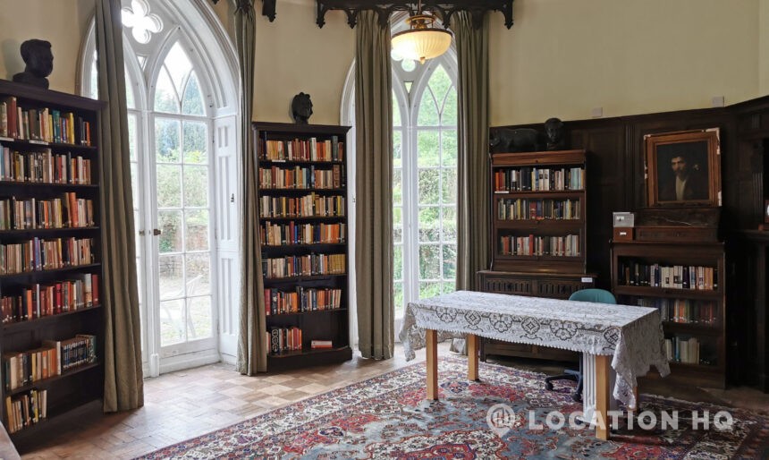 Panelled library with antique books and historic décor